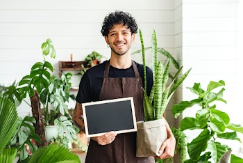 Small business owner holding an empty sign | Free stock photo | High Resolution image
