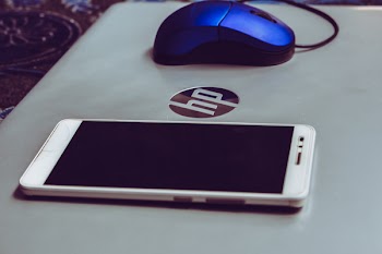 Smartphone On Top Of Grey Hp Laptop 