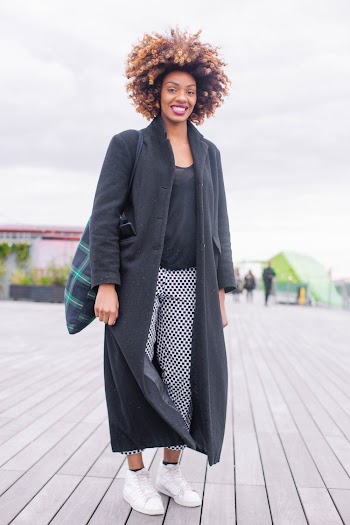 Smiling and Standing Woman Wearing Black Coat