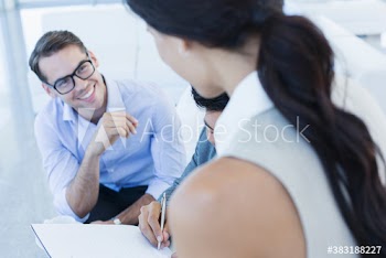 Smiling business people filling out paperwork