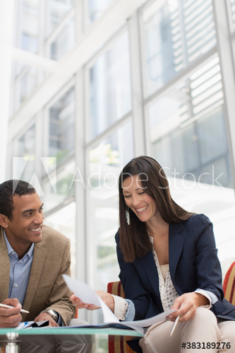 Smiling business people meeting in lobby