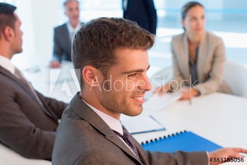 Smiling businessman listening in conference room meeting