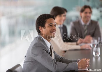 Smiling businessman listening in conference room meeting