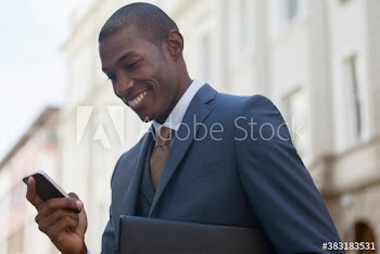 Smiling businessman using smart phone