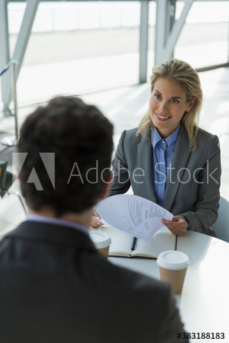 Smiling businesswoman talking with colleague in meeting