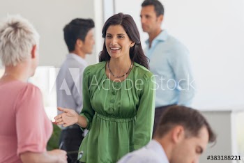 Smiling businesswoman talking with colleague in meeting