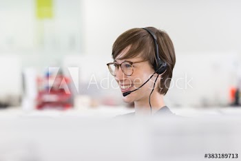 Smiling businesswoman with headset in office