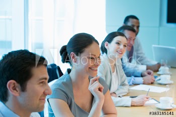Smiling corporate business people in conference room meeting