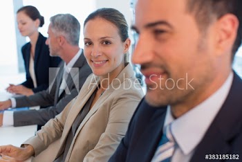 Smiling corporate businesswoman in conference room meeting