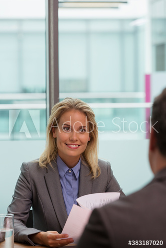 Smiling corporate businesswoman in conference room meeting