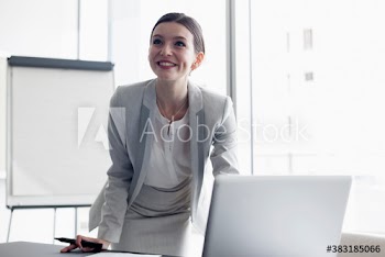 Smiling corporate businesswoman preparing for meeting at laptop