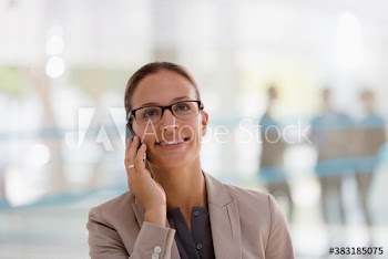 Smiling corporate businesswoman talking on smart phone