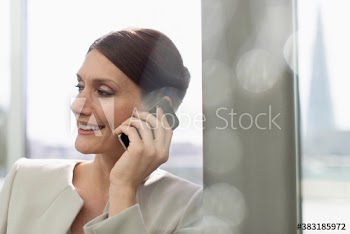 Smiling corporate businesswoman talking on smart phone