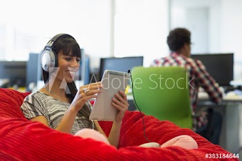 Smiling creative businesswoman working in beanbag chair