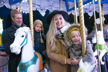 Smiling Family On Merry Go Round