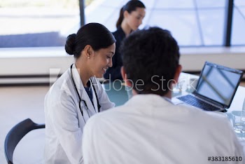 Smiling female doctor in hospital meeting