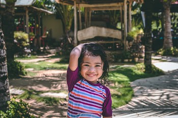 Smiling Girl Wearing Purple and Multicolored Striped Top
