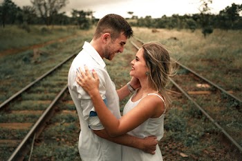 Smiling Man and Woman Facing Each Other Beside Railway Train