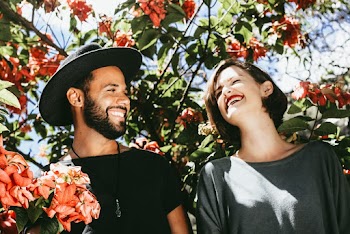 Smiling Man and Woman Standing Below Trees