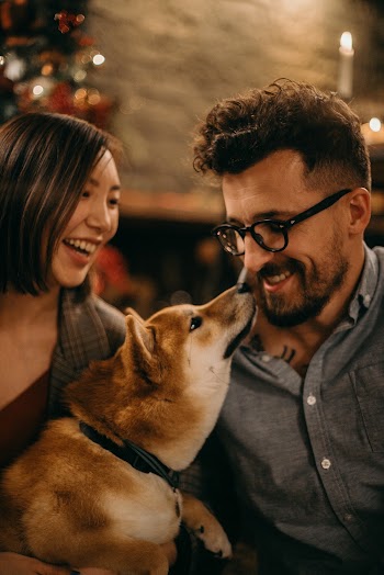 Smiling Man and Woman With Dog