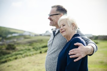 Smiling Man Holding Woman's Left Shoulder
