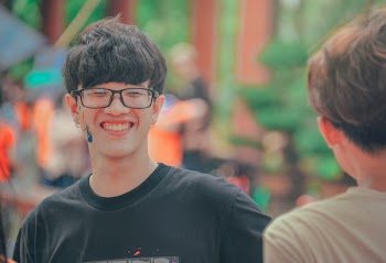Smiling Man in Black Shirt Wearing Eyeglasses