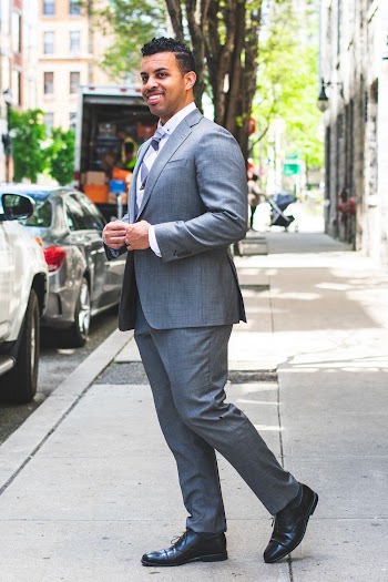 Smiling Man In Grey Suit Standing On Sidewalk