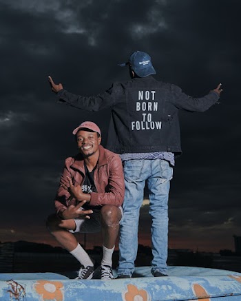 Smiling Man Sitting Near Another Man Standing