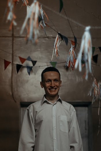Smiling Man Standing Inside Room