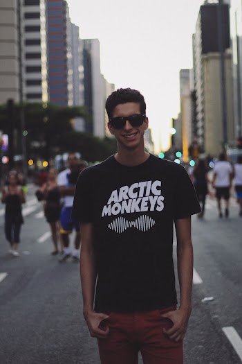 Smiling Man Standing on Road Near Buildings