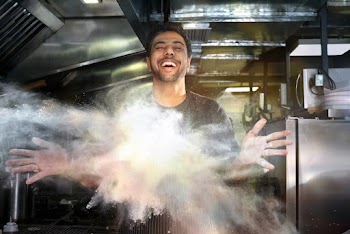 Smiling Man Throwing White Powder