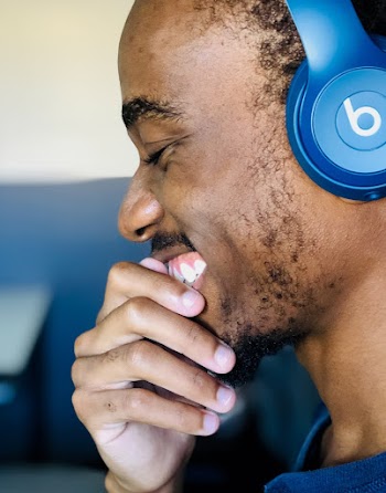 Smiling Man Using Blue Beats Headphones