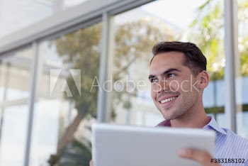 Smiling man using digital tablet on patio