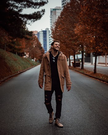 Smiling Man Walking Alone on Pathway
