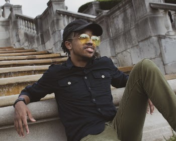 Smiling Man Wearing Black Long-sleeved Shirt Leaning Behind Concrete Stairs
