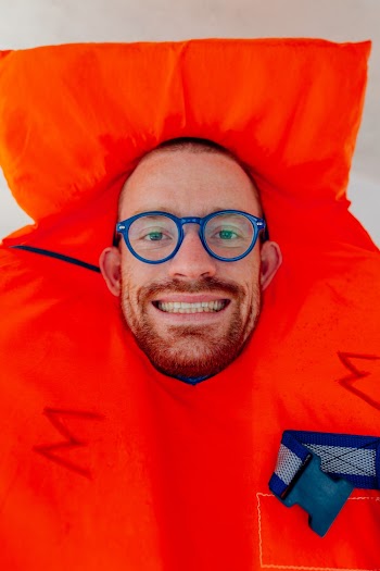 Smiling Man Wearing Blue Framed Eyeglasses