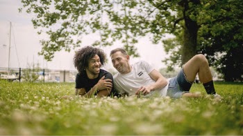 Smiling Men Lying on Grass