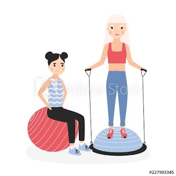 Smiling mother and daughter performing aerobics exercises with gym balls