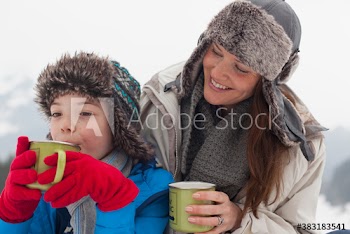 Smiling mother and son drinking hot cocoa