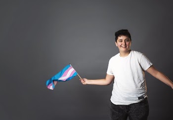 Smiling Person Waving Trans Pride Flag
