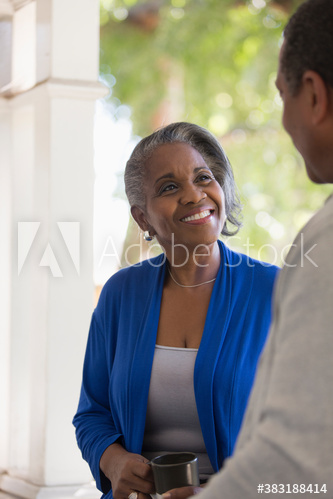 Smiling senior couple talking on porch