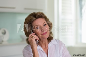 Smiling senior woman talking on telephone