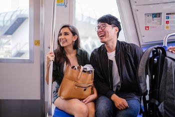 Smiling Woman And Man Inside Train