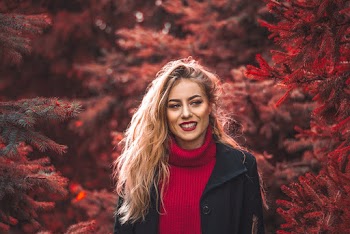 Smiling Woman Beside Red Tree