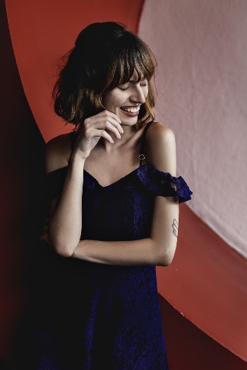Smiling Woman Facing Her Left With Eyes Closed