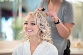 Smiling Woman Getting Hair Curled By Another Woman