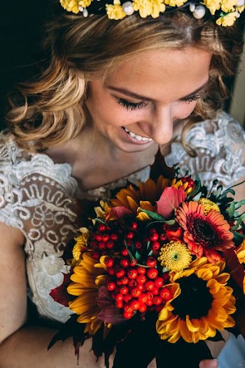 smiling woman holding bouquet of flowers