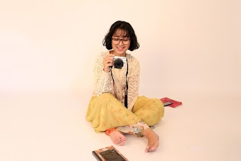 Smiling Woman Holding Camera