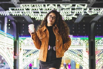 Smiling Woman Holding Disposable Cup