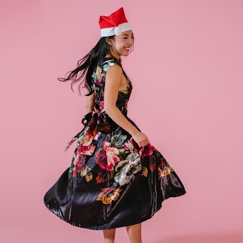Smiling Woman Holding Dress Skirt